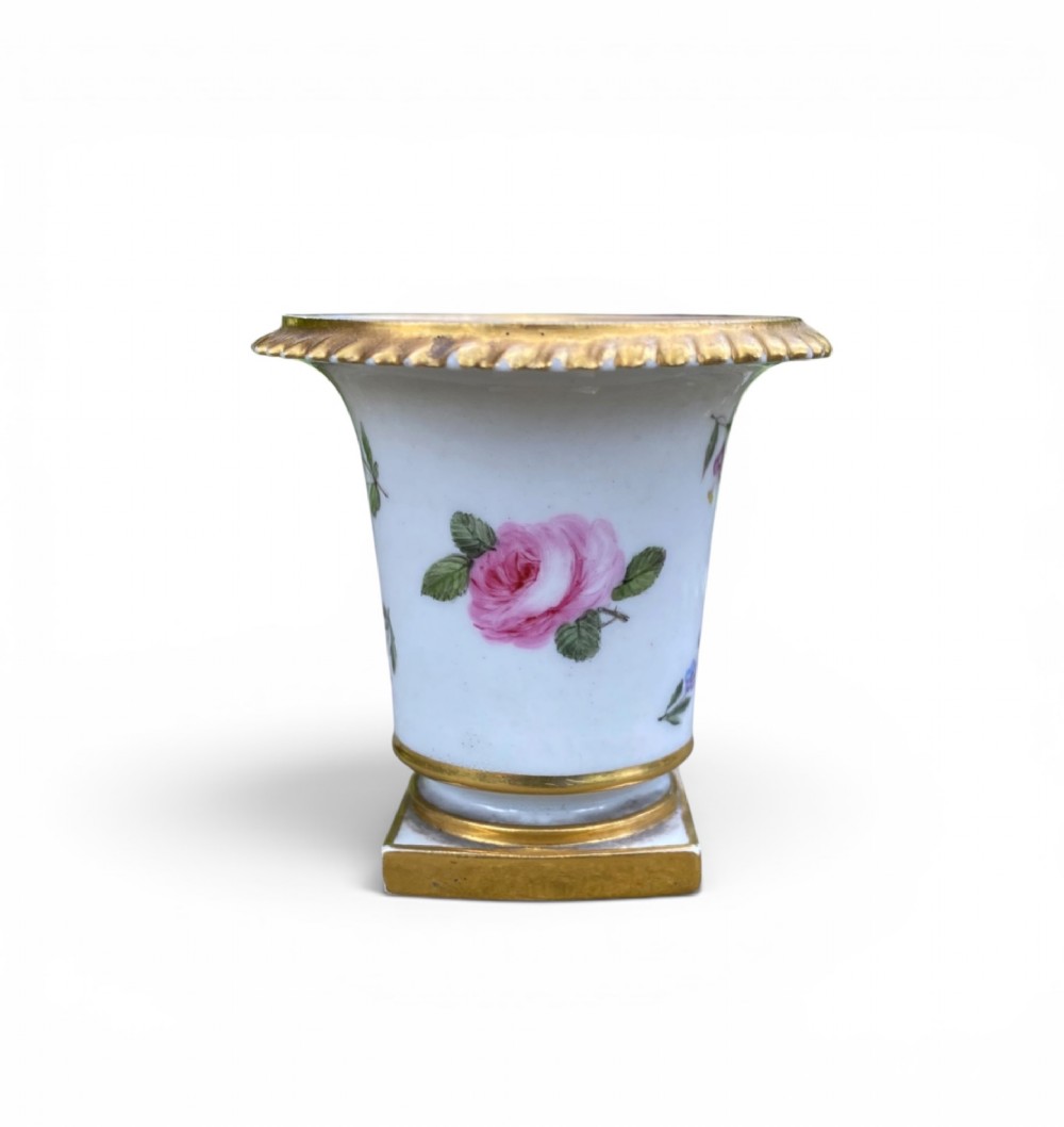 A flared white antique porcelain vase decorated with hand-painted pink and purple flowers and a square gilded pedestal base. View III