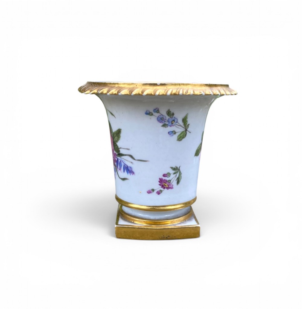A flared white antique porcelain vase decorated with hand-painted pink and purple flowers and a square gilded pedestal base. View IV