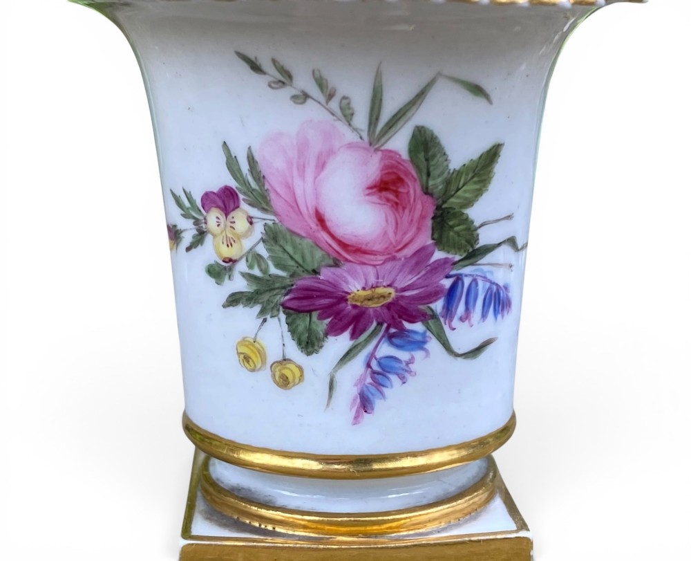 A flared white antique porcelain vase decorated with hand-painted pink and purple flowers and a square gilded pedestal base. View VI
