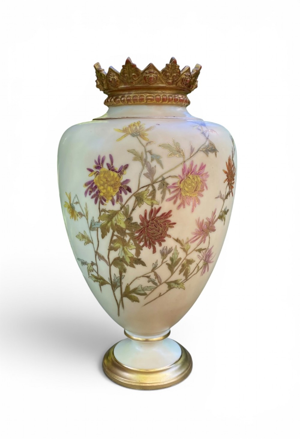 An urn-shaped ivory porcelain vase featuring hand-painted botanical chrysanthemum flowers, an ornate pierced crown rim, and gilded accents.