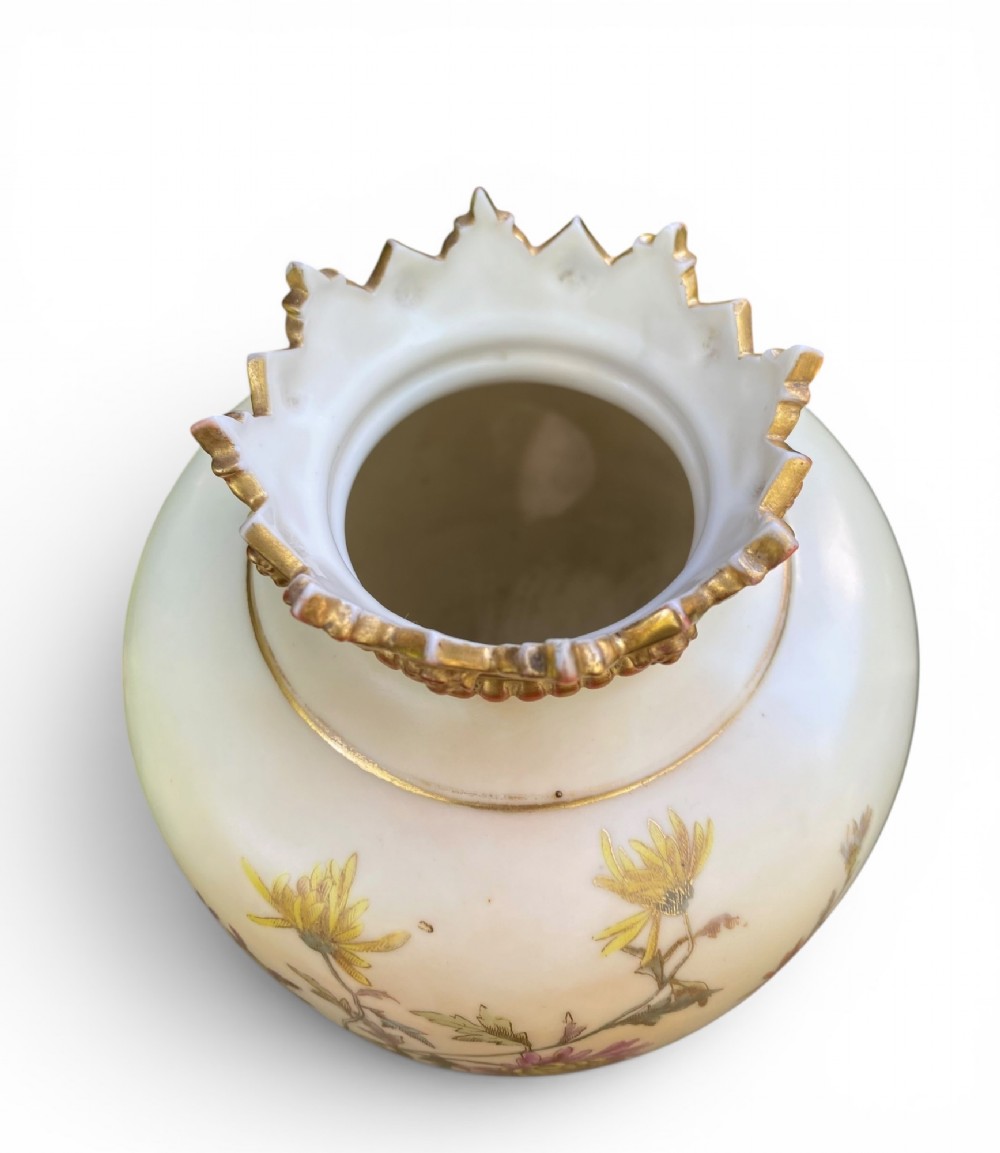 An urn-shaped ivory porcelain vase featuring hand-painted botanical chrysanthemum flowers, an ornate pierced crown rim, and gilded accents. View VIII
