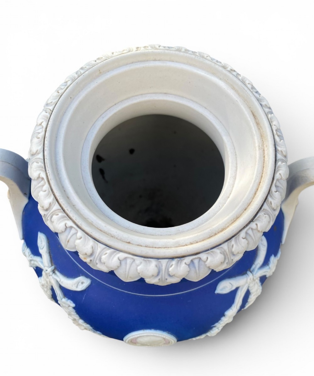 A cobalt blue jasperware pot pourri urn on a matching cylindrical pedestal, featuring white raised relief swags, classical medallions, scroll handles, and a pierced lid. View XI