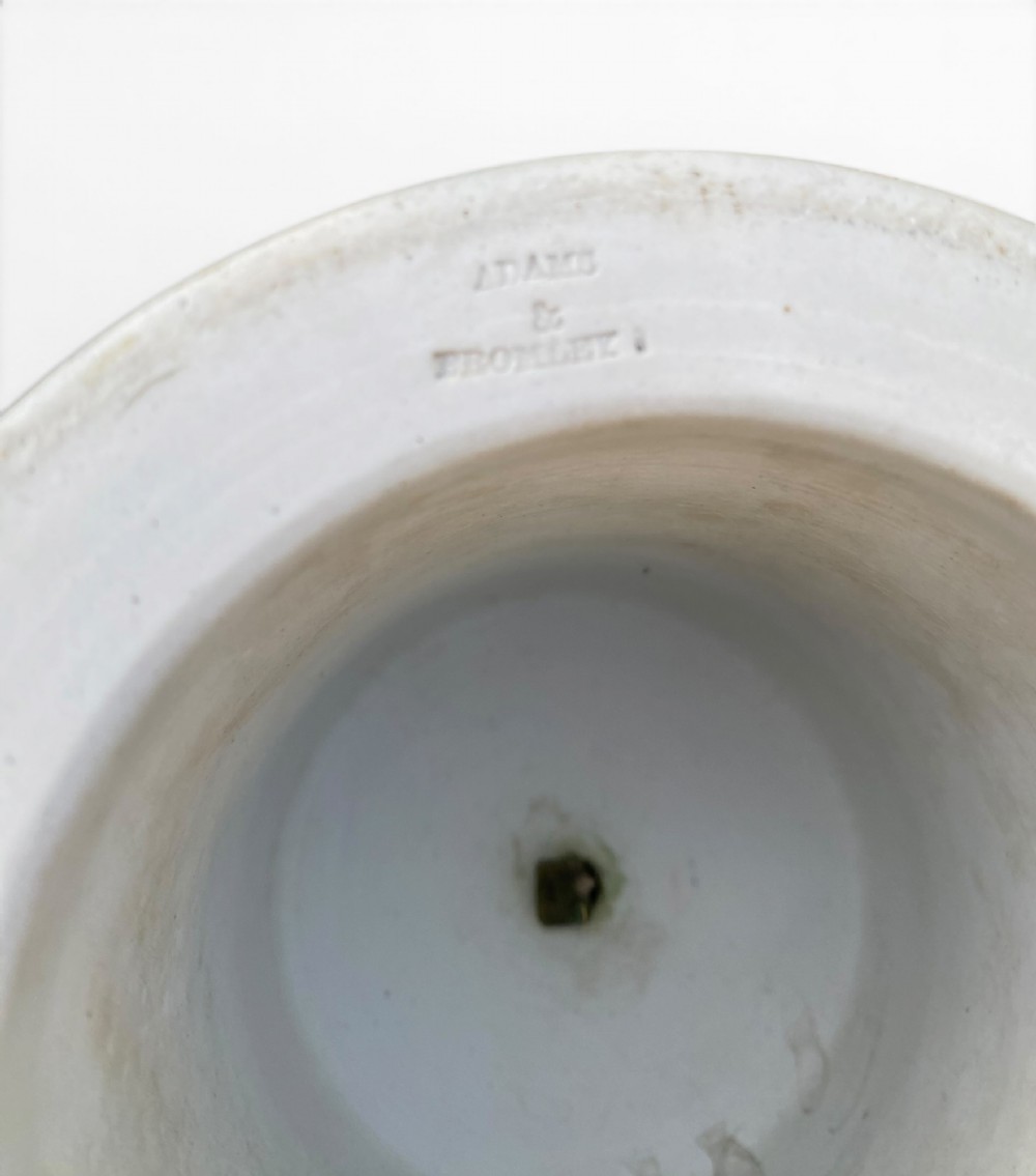A cobalt blue jasperware pot pourri urn on a matching cylindrical pedestal, featuring white raised relief swags, classical medallions, scroll handles, and a pierced lid. View XII