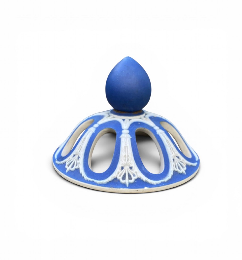 A cobalt blue jasperware pot pourri urn on a matching cylindrical pedestal, featuring white raised relief swags, classical medallions, scroll handles, and a pierced lid. View XIII