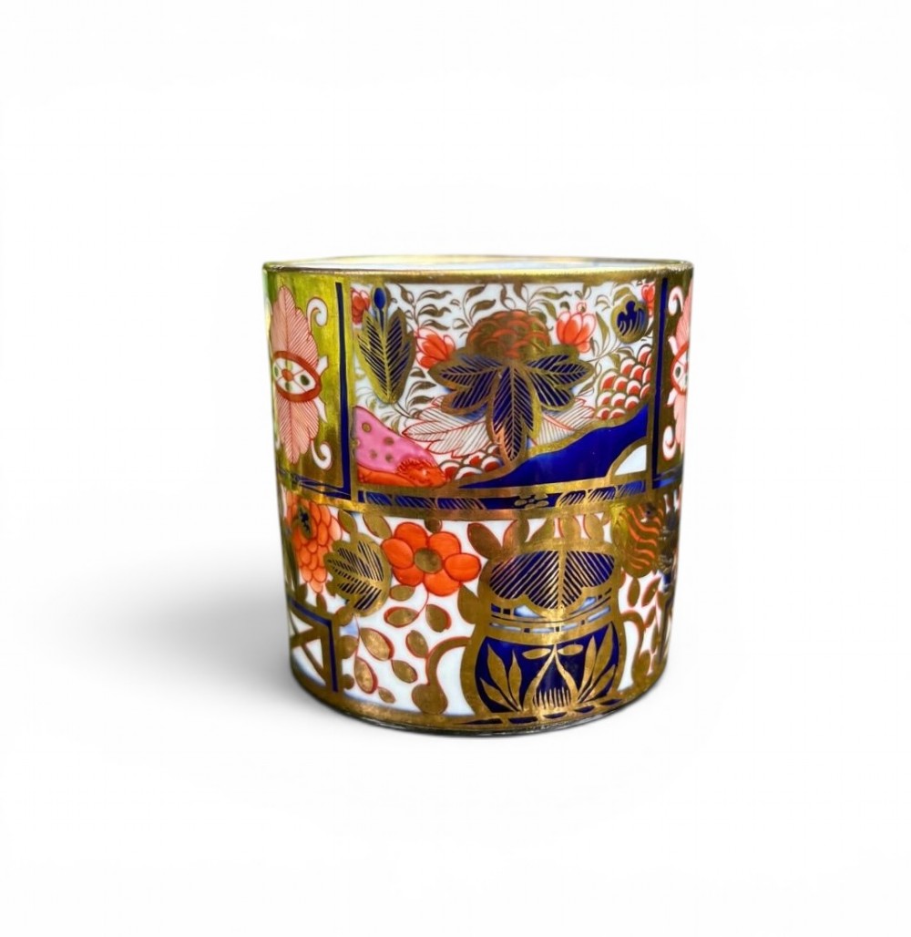 A straight-sided Georgian porcelain coffee can decorated in a Japanese-inspired Imari pattern with cobalt blue, terracotta red, and intricate gold gilding. View II