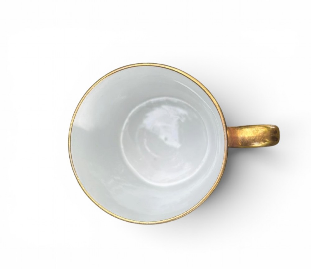 A straight-sided Georgian porcelain coffee can decorated in a Japanese-inspired Imari pattern with cobalt blue, terracotta red, and intricate gold gilding. View V
