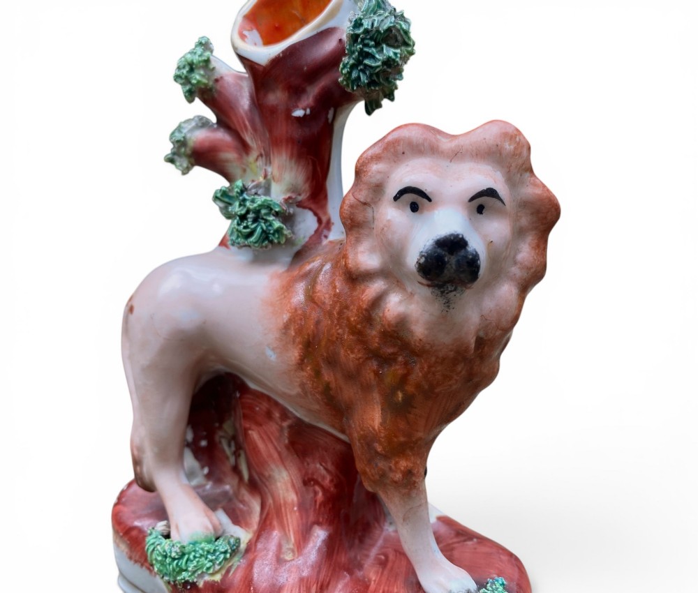 A pair of antique Victorian Staffordshire ceramic spill vases in the form of standing lions beside hollow tree trunks. View III