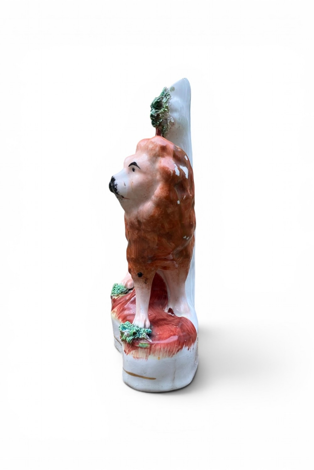 A pair of antique Victorian Staffordshire ceramic spill vases in the form of standing lions beside hollow tree trunks. View IV