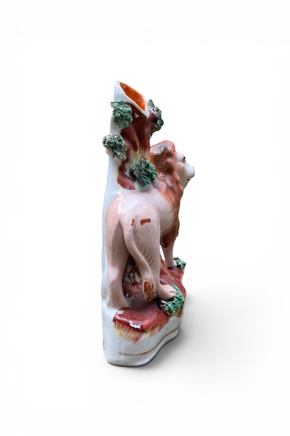 A pair of antique Victorian Staffordshire ceramic spill vases in the form of standing lions beside hollow tree trunks. View VI