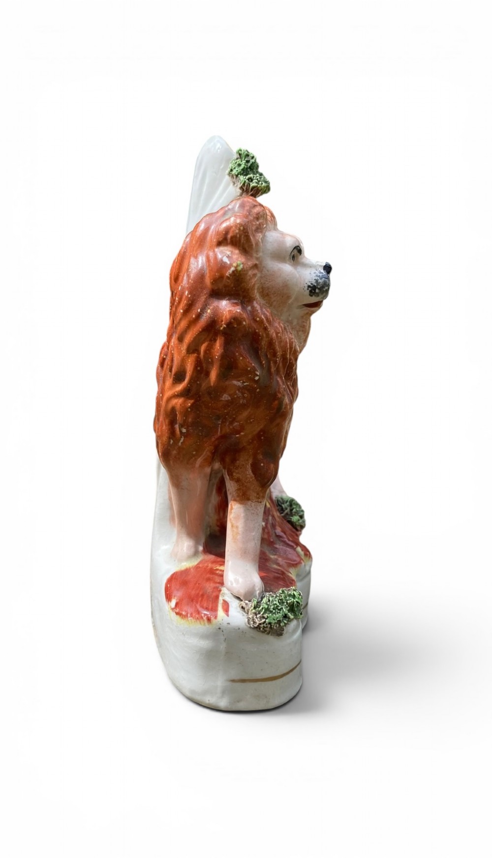 A pair of antique Victorian Staffordshire ceramic spill vases in the form of standing lions beside hollow tree trunks. View X