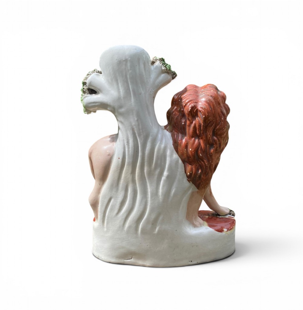 A pair of antique Victorian Staffordshire ceramic spill vases in the form of standing lions beside hollow tree trunks. View XI