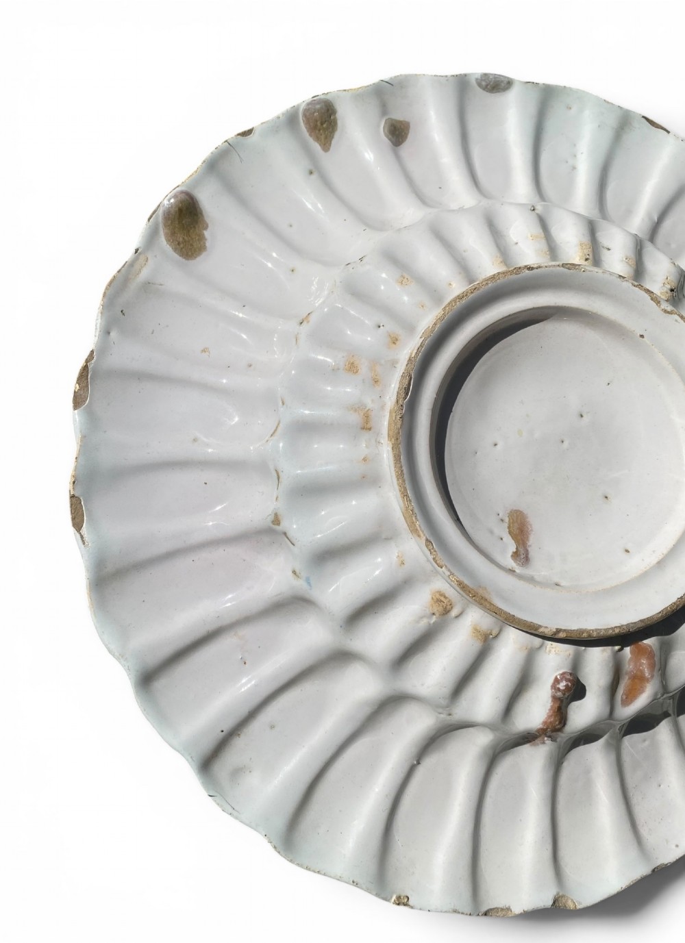 A circular antique Dutch Delft tin-glazed earthenware charger featuring hand-painted polychrome floral motifs in blue, yellow, and green across a fluted lobed rim and central basin. View V