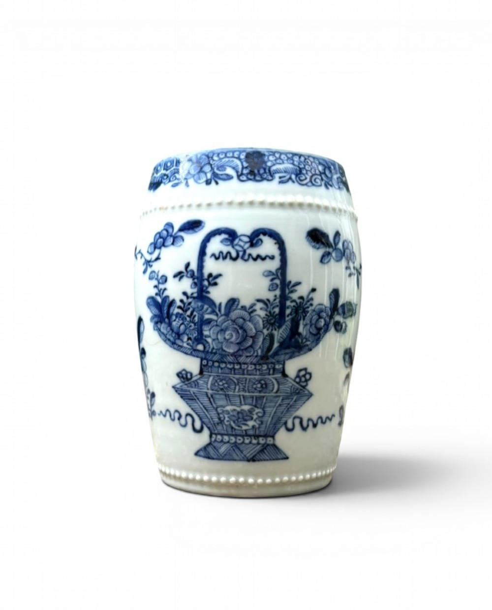 A barrel-shaped Chinese export porcelain mug decorated with a blue painted flower basket motif and raised beaded rims.