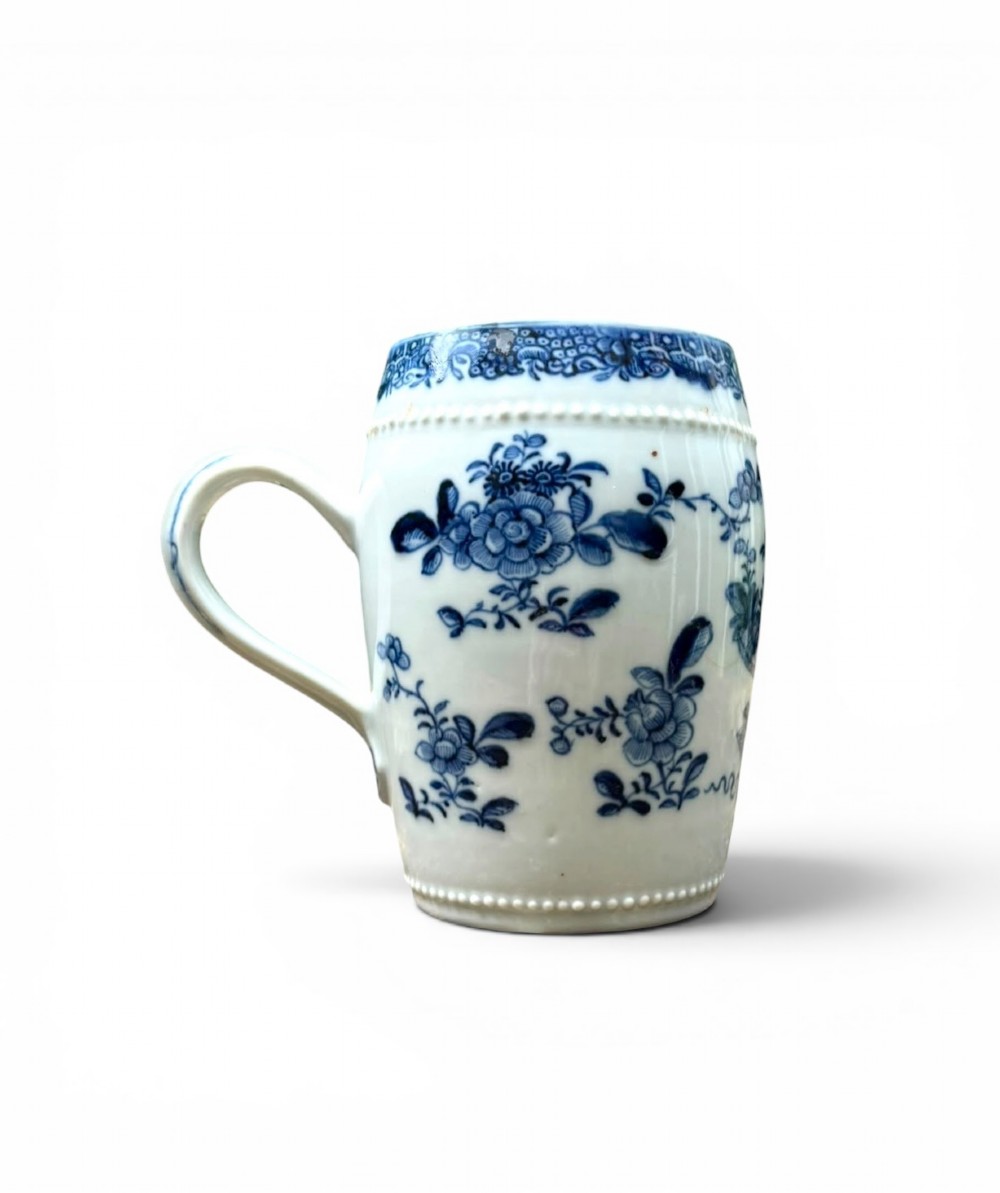 A barrel-shaped Chinese export porcelain mug decorated with a blue painted flower basket motif and raised beaded rims. View II