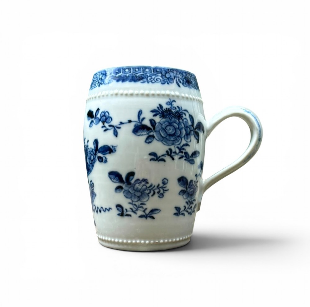 A barrel-shaped Chinese export porcelain mug decorated with a blue painted flower basket motif and raised beaded rims. View III