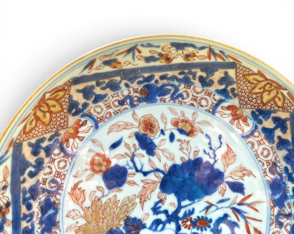 An 18th-century Chinese Imari porcelain dish decorated with underglaze cobalt blue foliage, iron-red enamel florals, and geometric diaper border patterns. View III