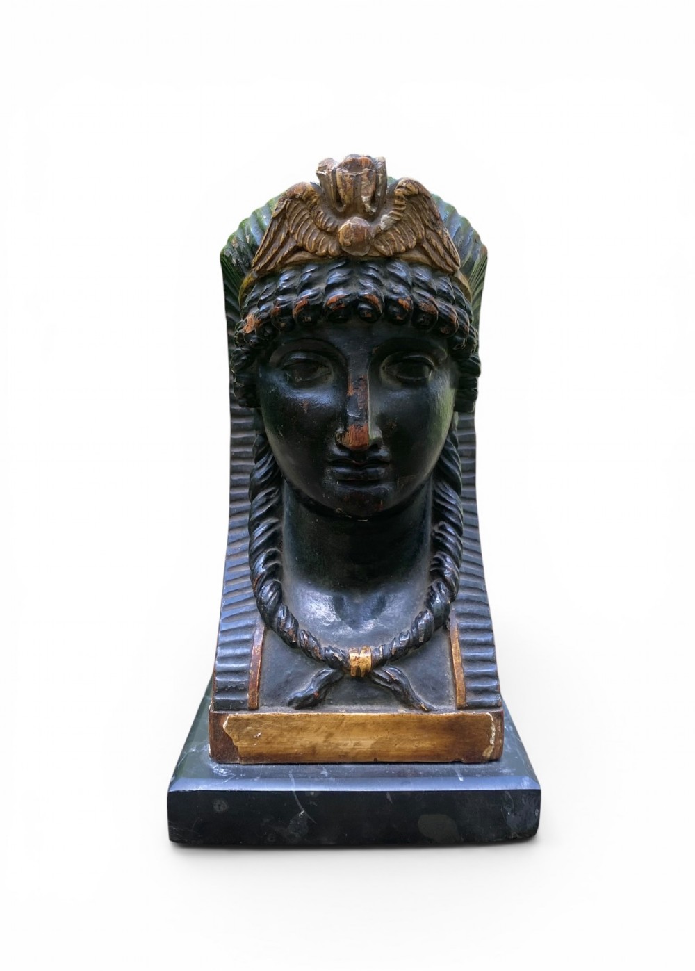 A facing pair of carved dark wood sphinx busts with gilt highlights mounted on rectangular black marble bases. View III