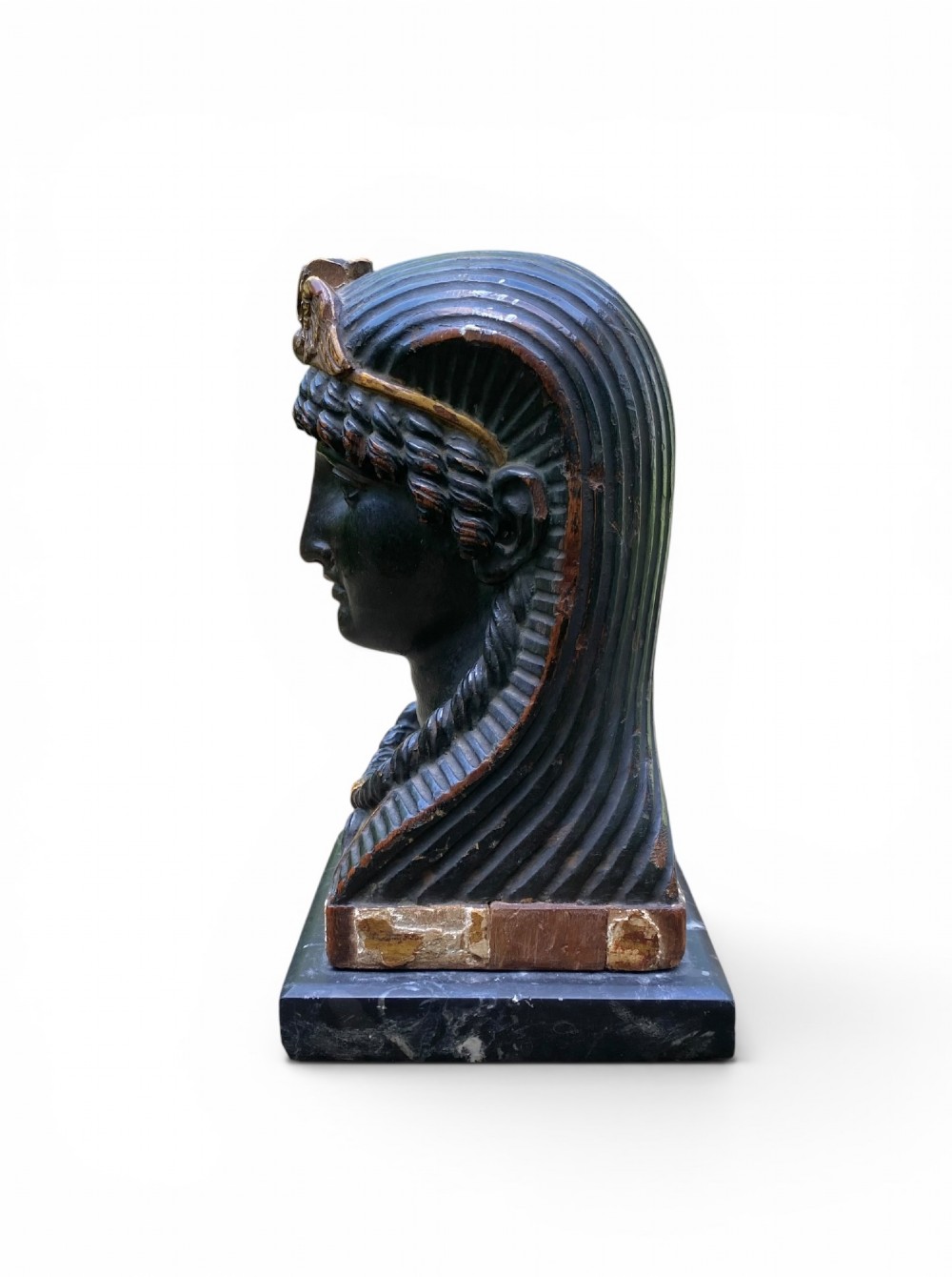 A facing pair of carved dark wood sphinx busts with gilt highlights mounted on rectangular black marble bases. View VI