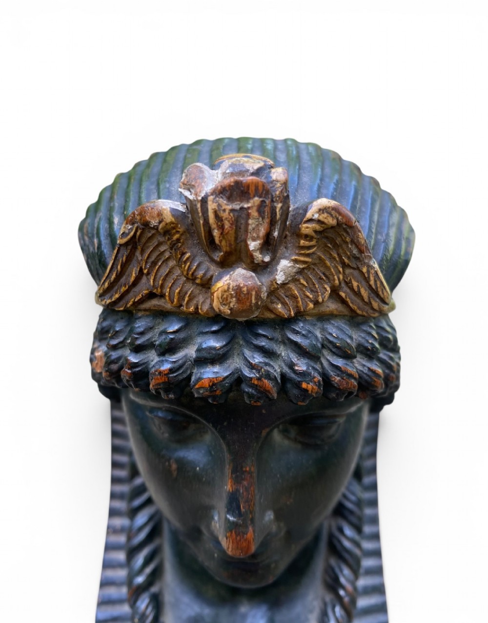 A facing pair of carved dark wood sphinx busts with gilt highlights mounted on rectangular black marble bases. View VII