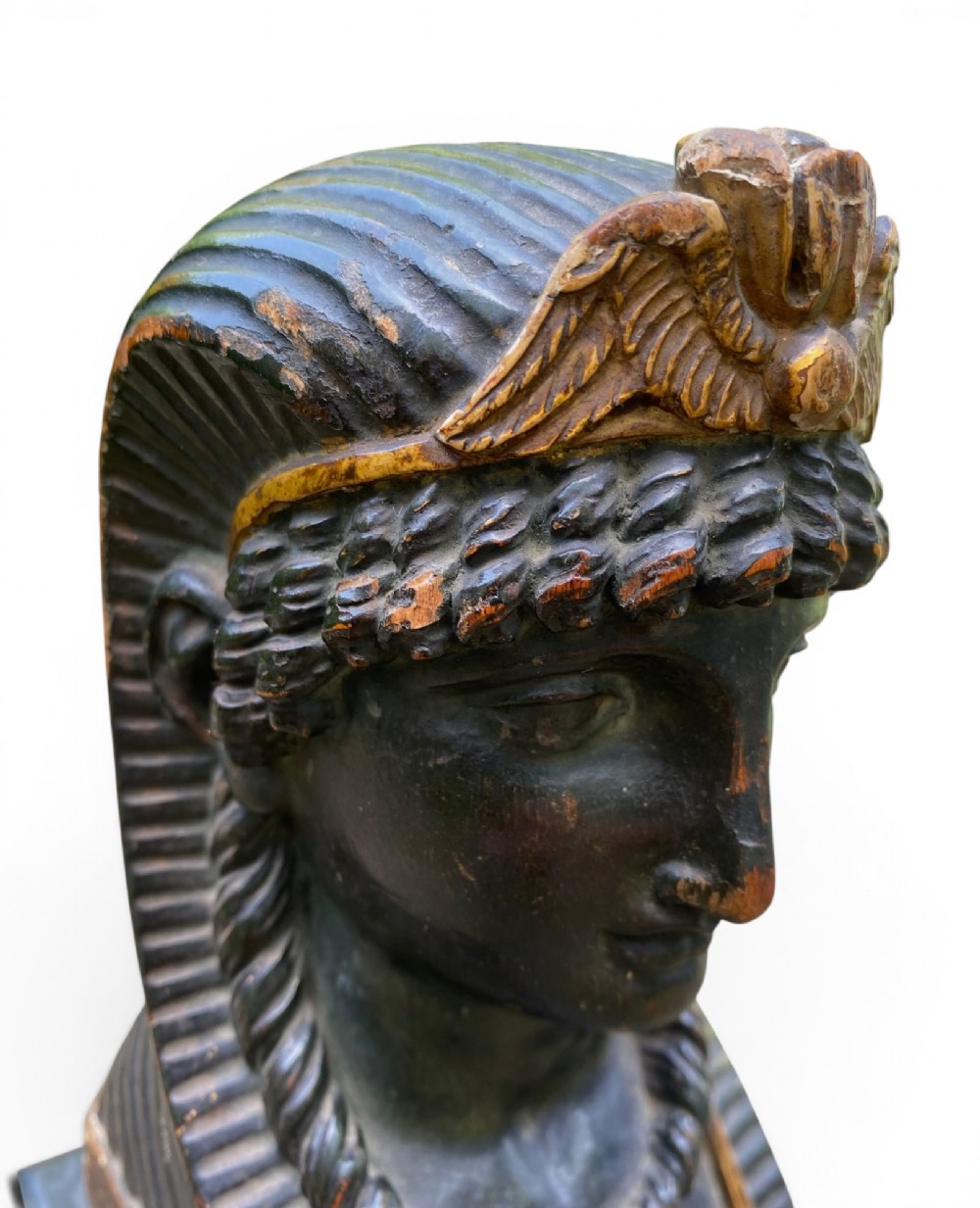 A facing pair of carved dark wood sphinx busts with gilt highlights mounted on rectangular black marble bases. View IX