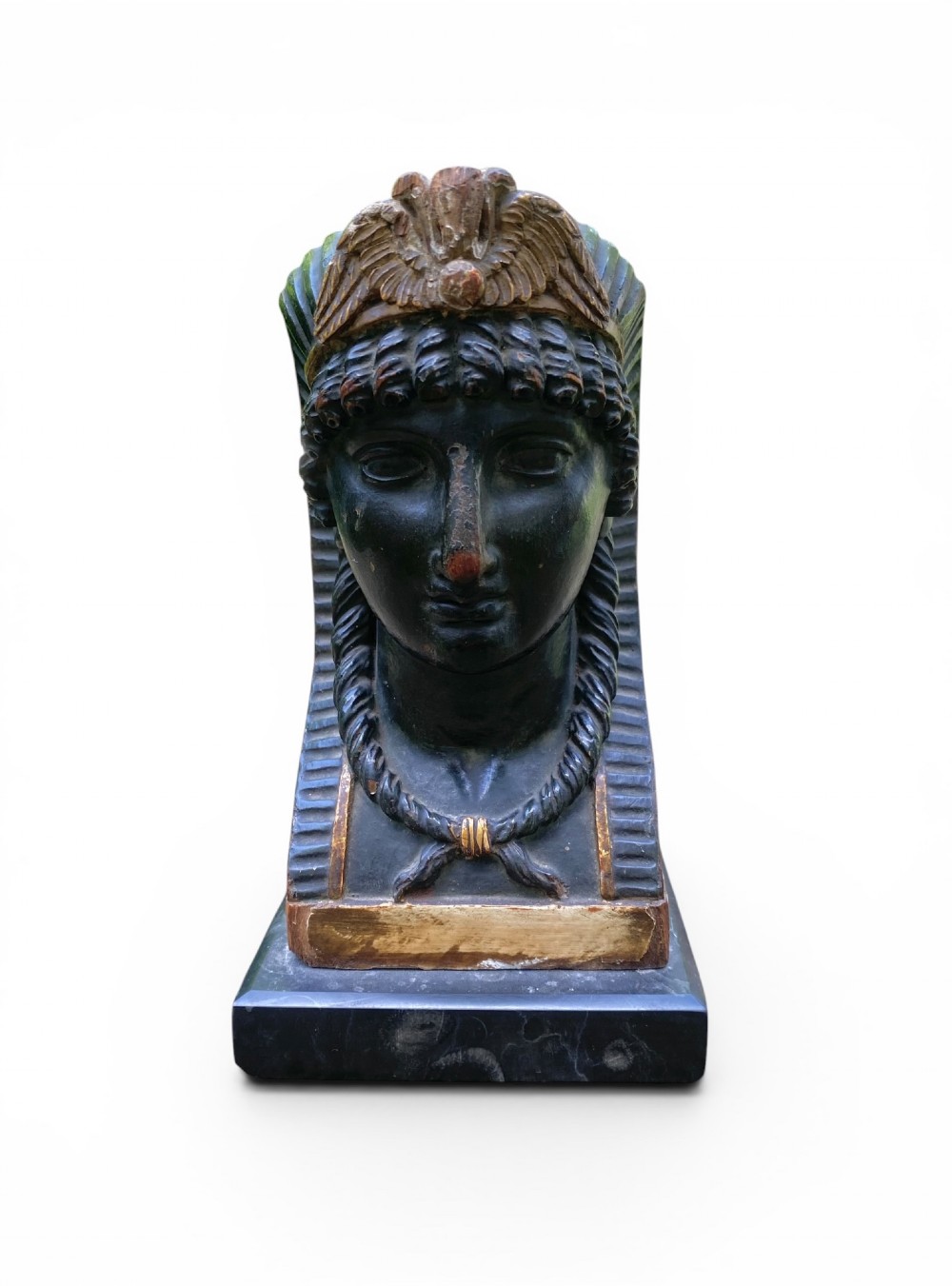 A facing pair of carved dark wood sphinx busts with gilt highlights mounted on rectangular black marble bases. View XI
