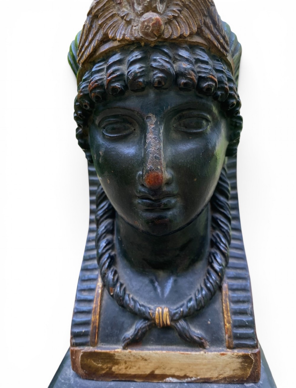 A facing pair of carved dark wood sphinx busts with gilt highlights mounted on rectangular black marble bases. View XII