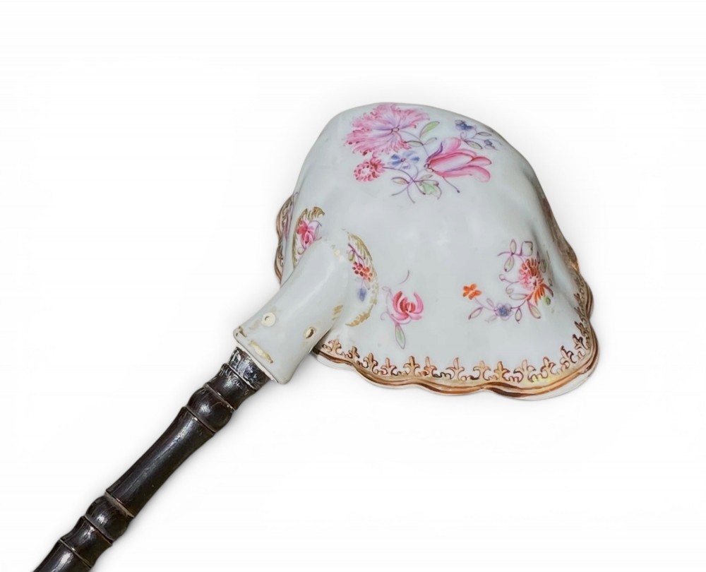 An 18th-century Chinese export famille rose porcelain ladle featuring a lobed white bowl painted with pink floral motifs and fitted with a dark turned handle. View V