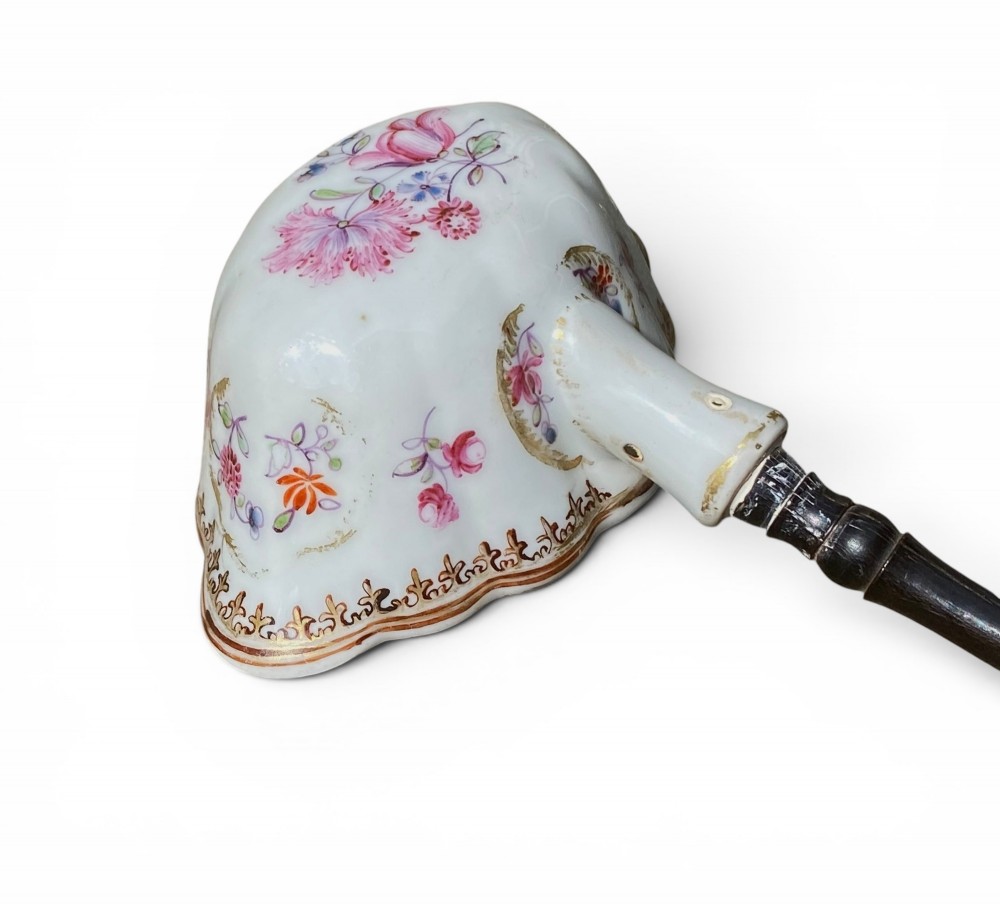 An 18th-century Chinese export famille rose porcelain ladle featuring a lobed white bowl painted with pink floral motifs and fitted with a dark turned handle. View VI