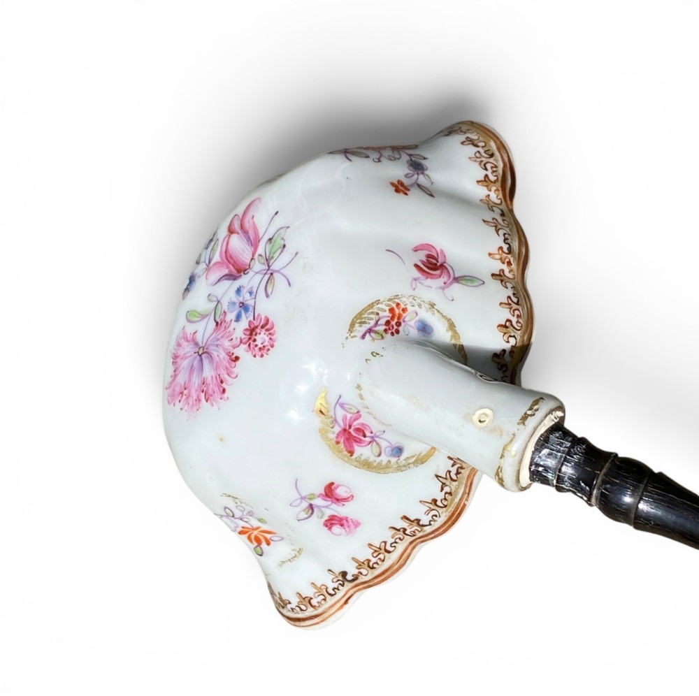 An 18th-century Chinese export famille rose porcelain ladle featuring a lobed white bowl painted with pink floral motifs and fitted with a dark turned handle. View VII