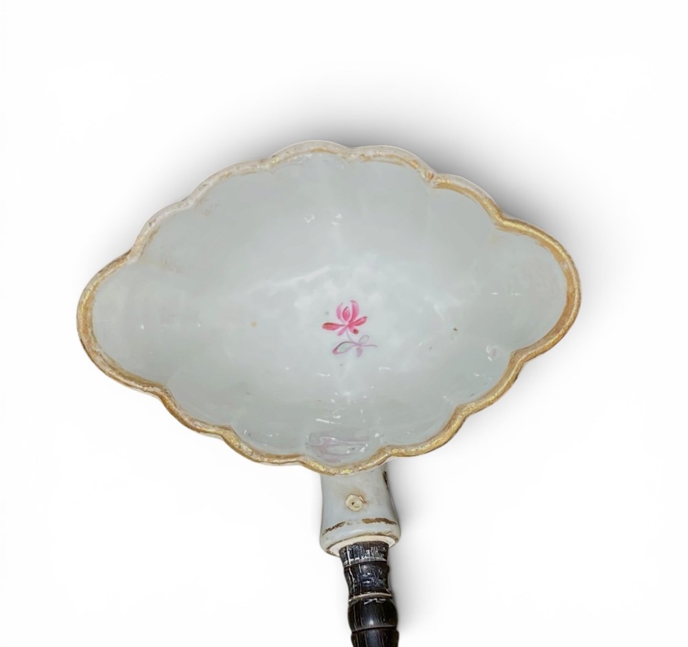 An 18th-century Chinese export famille rose porcelain ladle featuring a lobed white bowl painted with pink floral motifs and fitted with a dark turned handle. View VIII