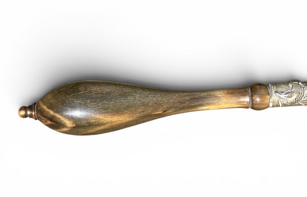 An 18th-century Chinese export famille rose porcelain ladle featuring a lobed white bowl painted with pink floral motifs and fitted with a dark turned handle. View IX