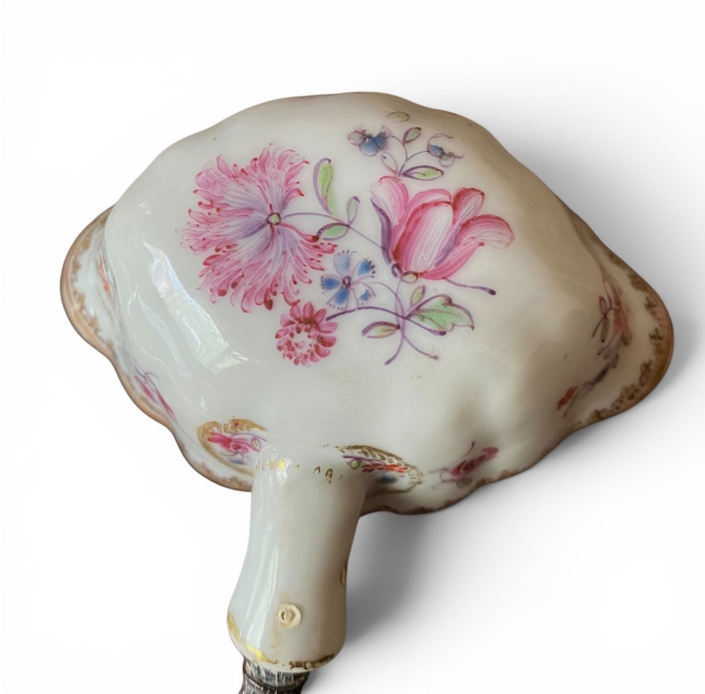 An 18th-century Chinese export famille rose porcelain ladle featuring a lobed white bowl painted with pink floral motifs and fitted with a dark turned handle. View XI