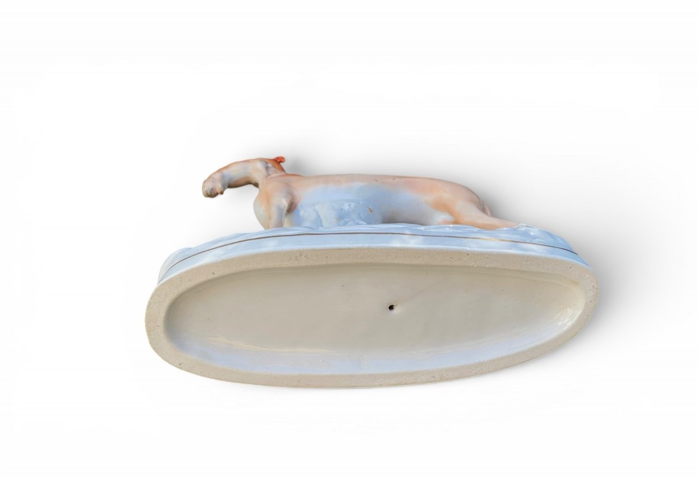 A pair of Victorian Staffordshire earthenware greyhound figurines standing facing each other, each holding a hare in its mouth on a white ceramic base. View XIII