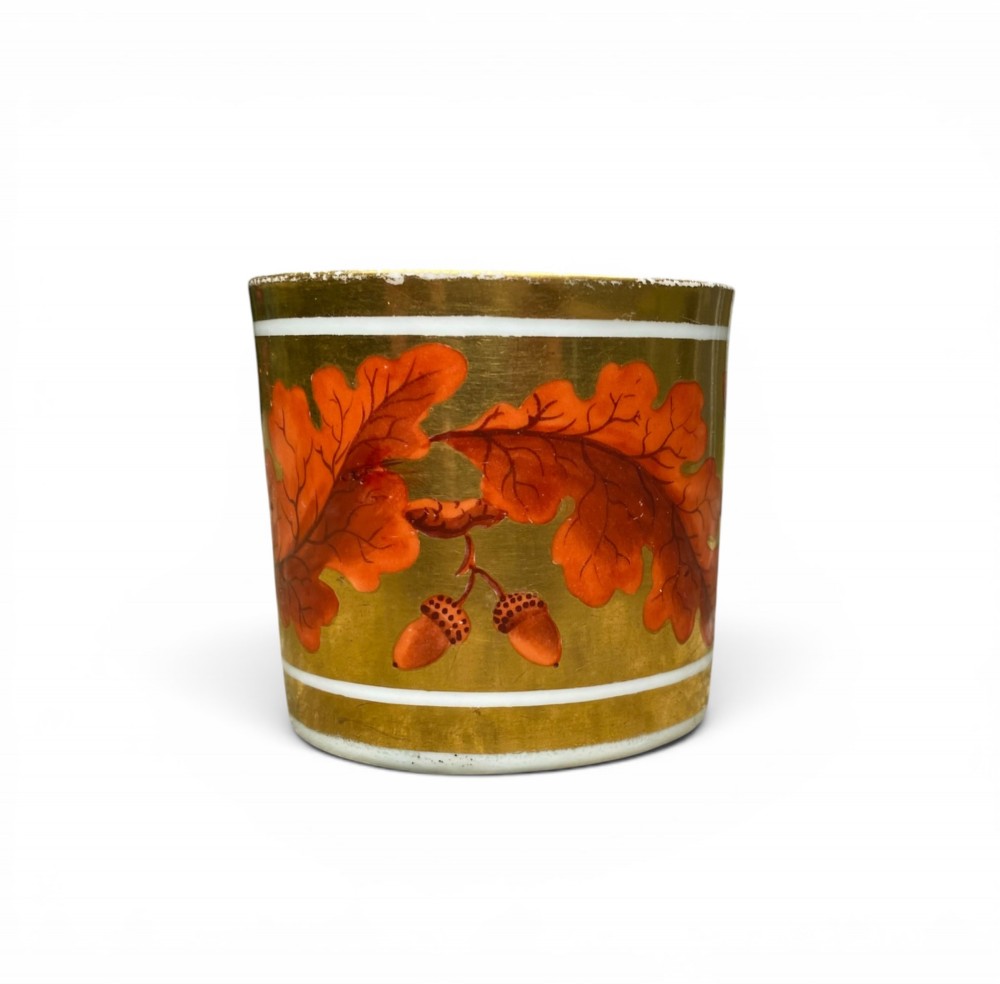 A Regency period Derby porcelain trio featuring two cups and a matching saucer decorated with red oak leaves and heavy gilding. View III