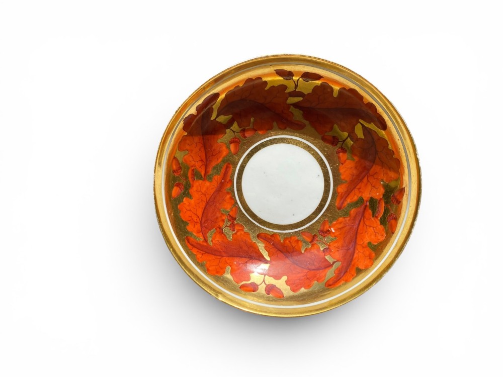 A Regency period Derby porcelain trio featuring two cups and a matching saucer decorated with red oak leaves and heavy gilding. View XI