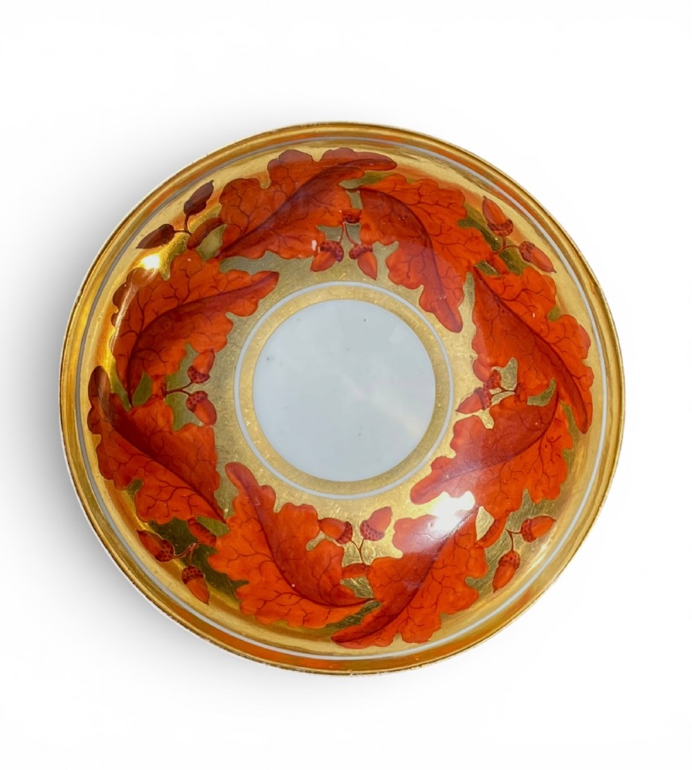 A Regency period Derby porcelain trio featuring two cups and a matching saucer decorated with red oak leaves and heavy gilding. View XII