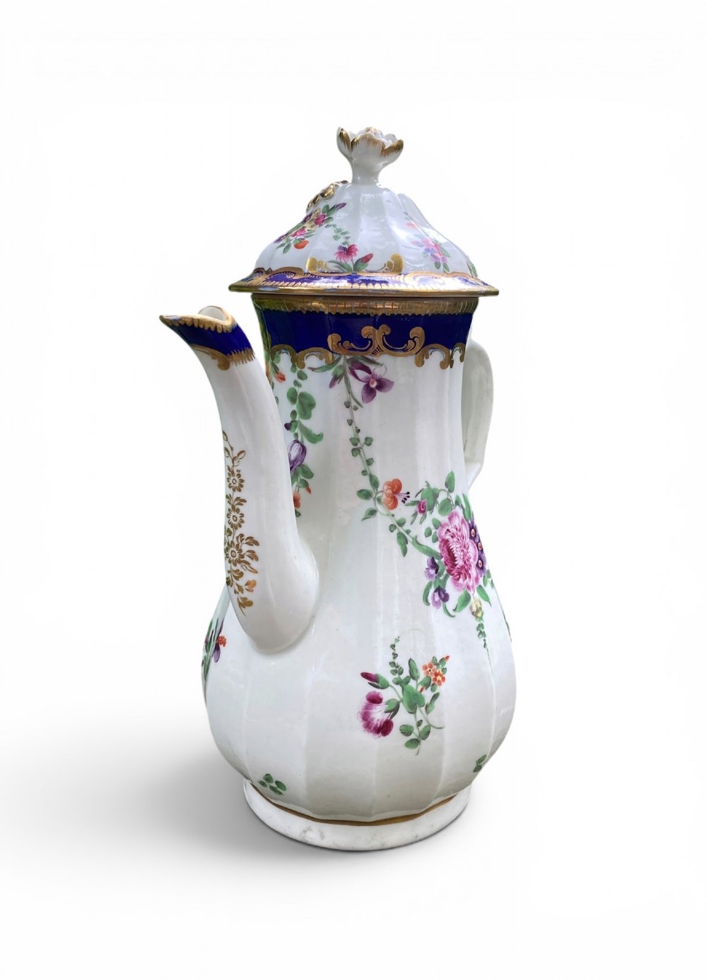 An 18th-century Worcester soft-paste porcelain coffee pot with a cobalt blue rim, hand-painted floral sprays, gilt detailing, and a matching lid with a flower finial. View II