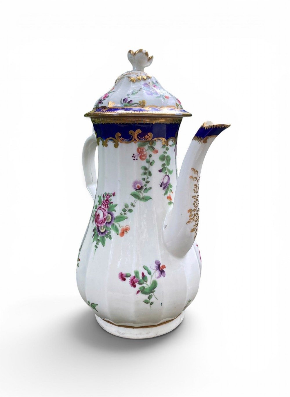 An 18th-century Worcester soft-paste porcelain coffee pot with a cobalt blue rim, hand-painted floral sprays, gilt detailing, and a matching lid with a flower finial. View IV