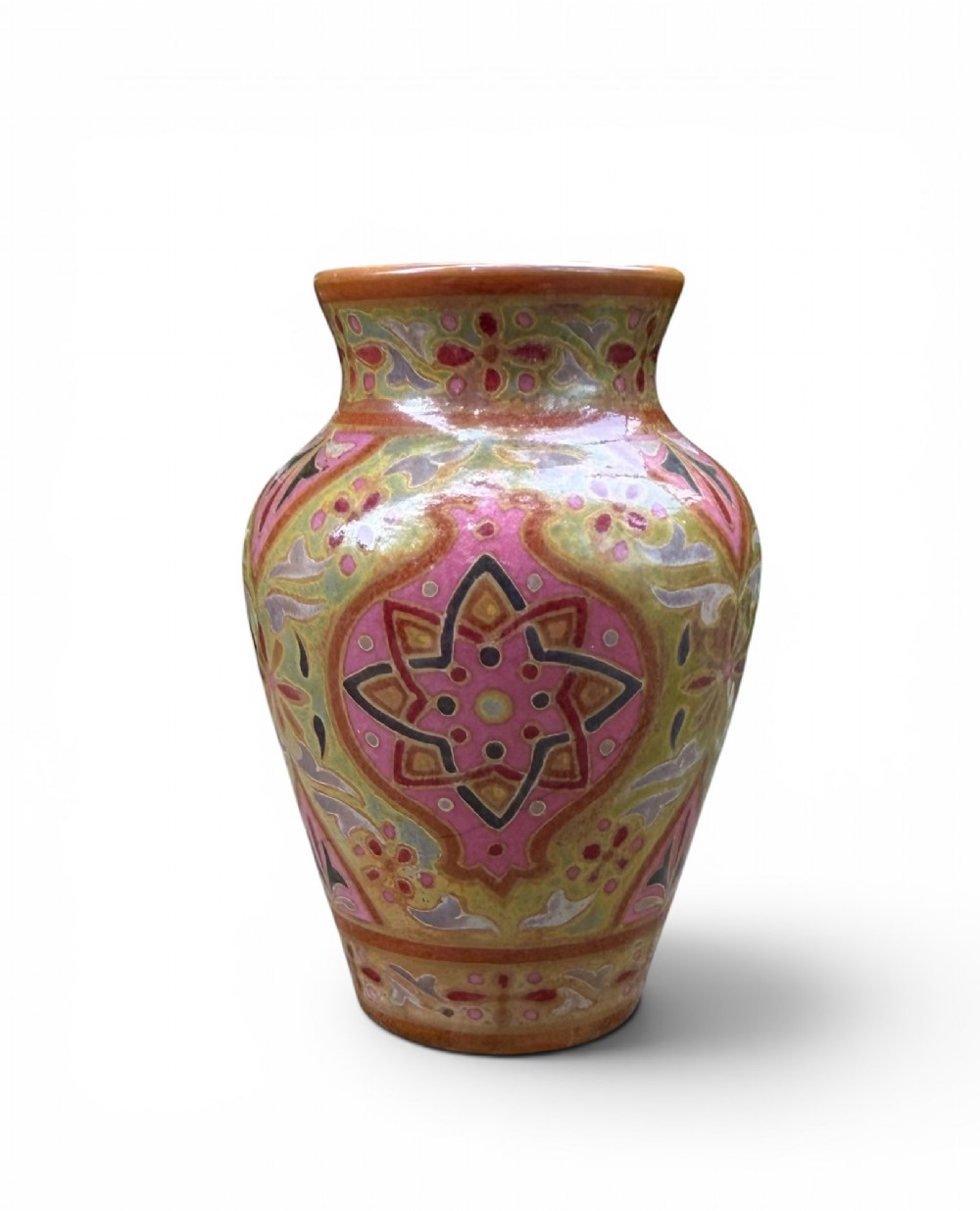 A baluster-shaped ceramic vase featuring intricate Persian-style geometric star medallions and foliate patterns in pink, olive green, and yellow lustre glazes.