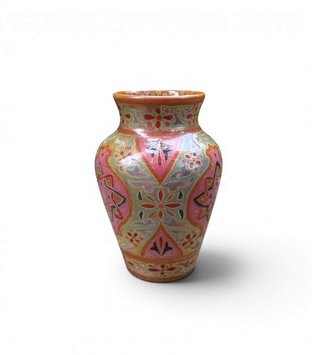 A baluster-shaped ceramic vase featuring intricate Persian-style geometric star medallions and foliate patterns in pink, olive green, and yellow lustre glazes. View IV