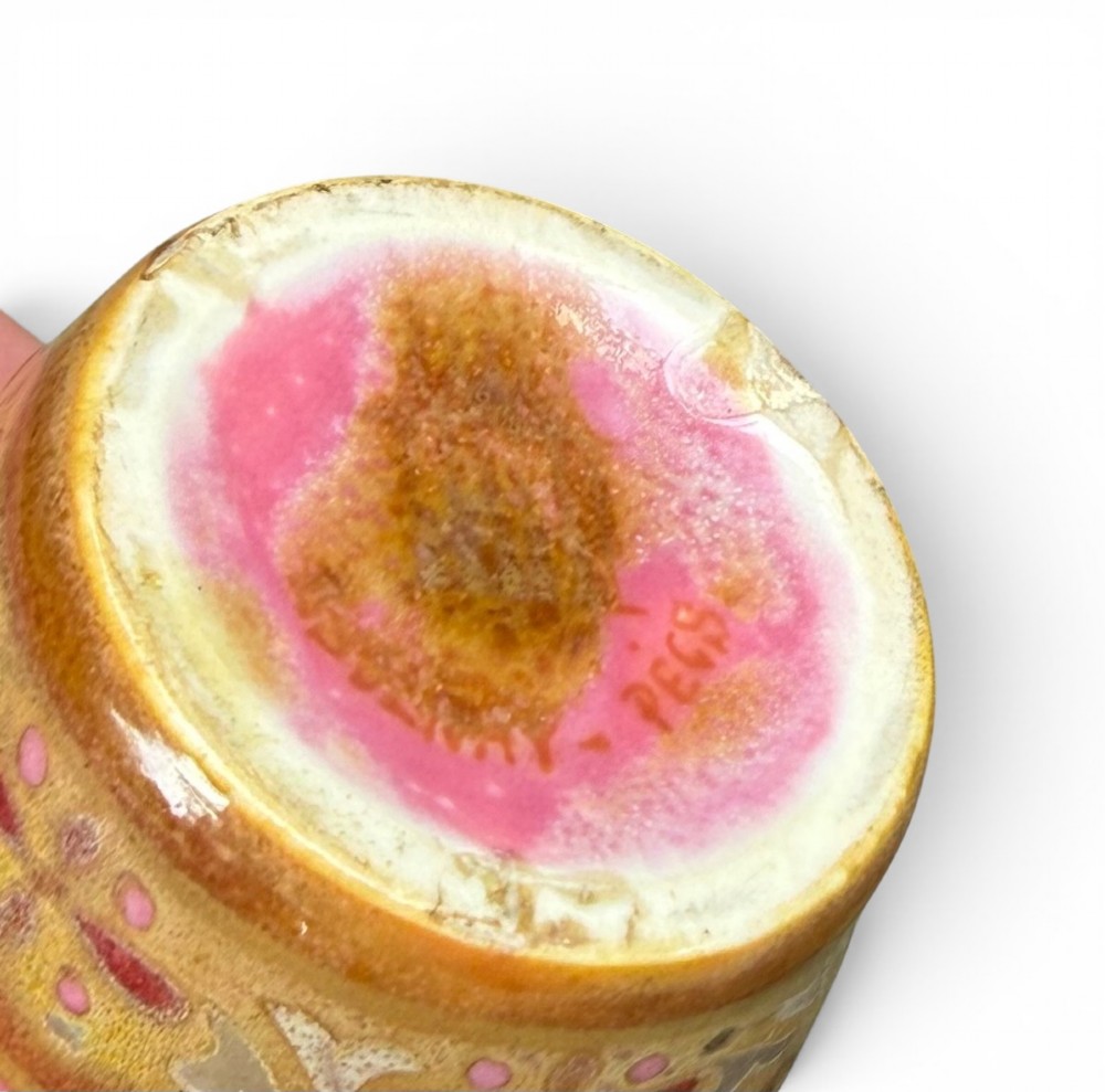 A baluster-shaped ceramic vase featuring intricate Persian-style geometric star medallions and foliate patterns in pink, olive green, and yellow lustre glazes. View VI