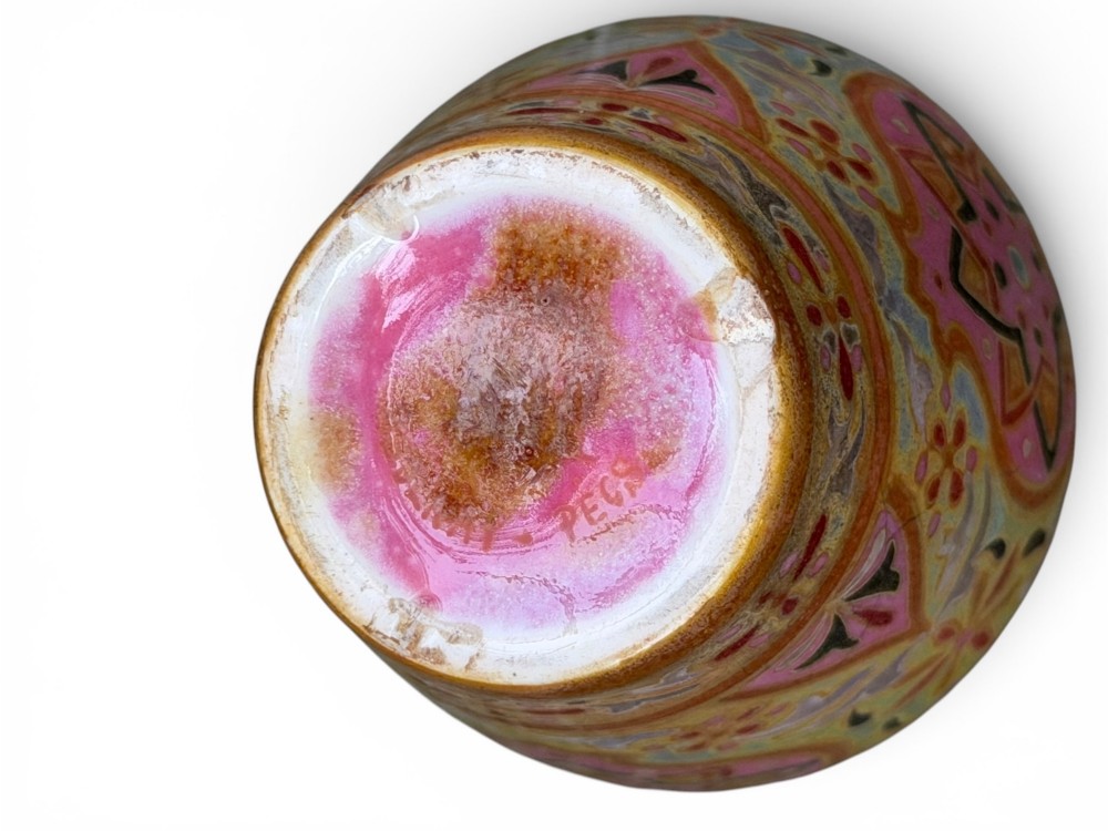 A baluster-shaped ceramic vase featuring intricate Persian-style geometric star medallions and foliate patterns in pink, olive green, and yellow lustre glazes. View VII