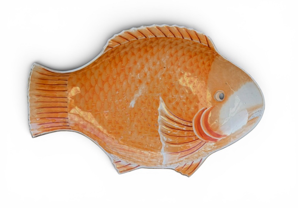 An antique Japanese Arita porcelain dish shaped like a fish with detailed orange hand-painted scales and fins.