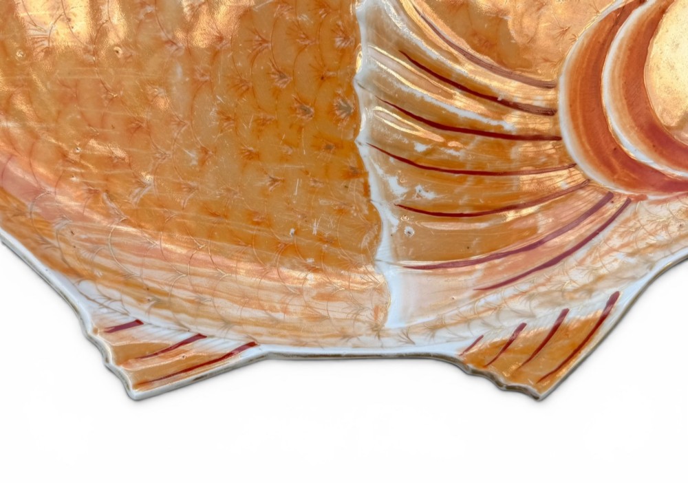 An antique Japanese Arita porcelain dish shaped like a fish with detailed orange hand-painted scales and fins. View IV
