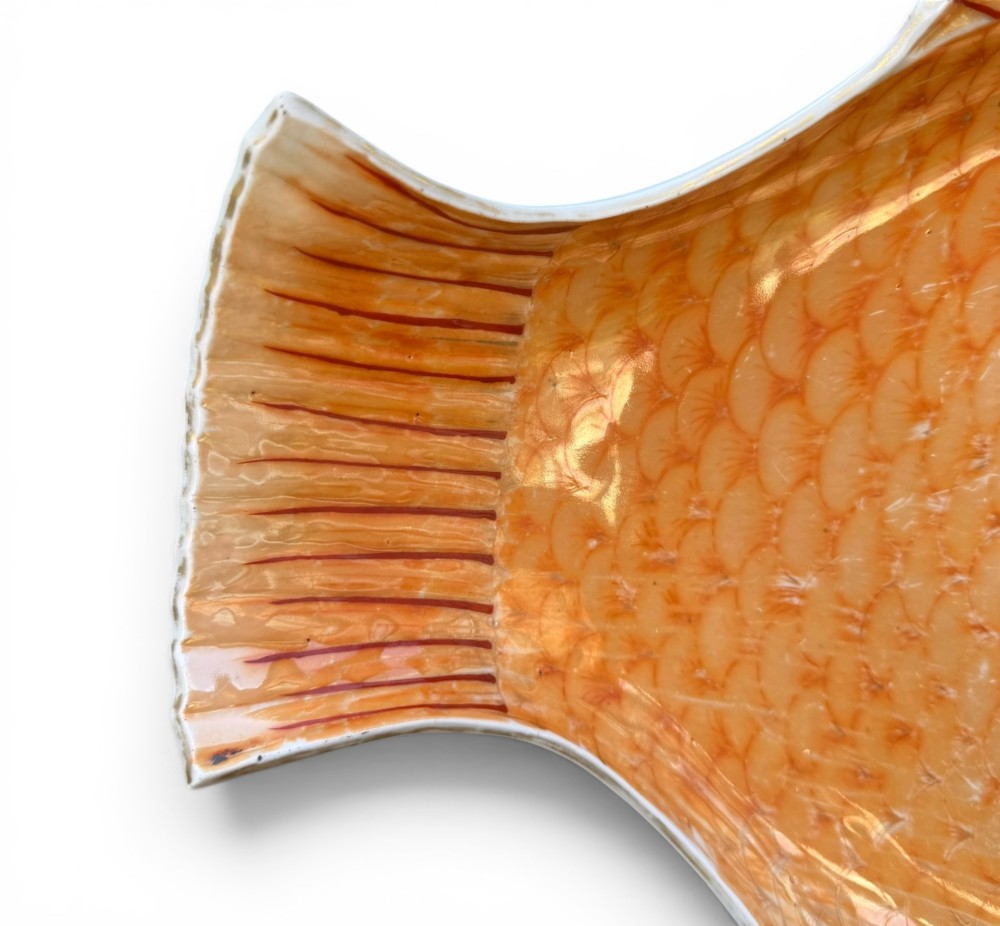 An antique Japanese Arita porcelain dish shaped like a fish with detailed orange hand-painted scales and fins. View V