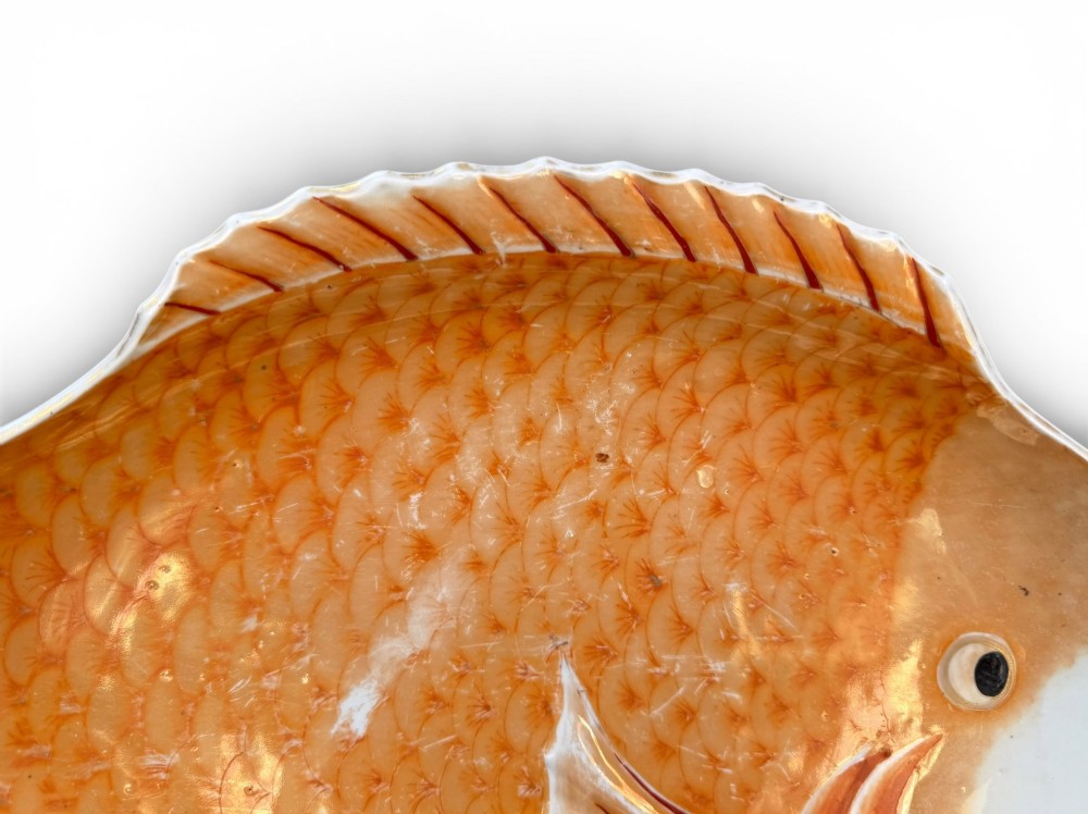 An antique Japanese Arita porcelain dish shaped like a fish with detailed orange hand-painted scales and fins. View VI