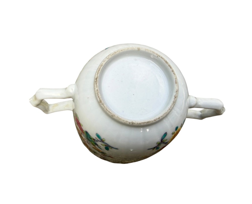 A Chinese export famille rose porcelain twin-handled cup and scalloped stand decorated with hand-painted floral motifs, birds, and gilt edges. View XIV