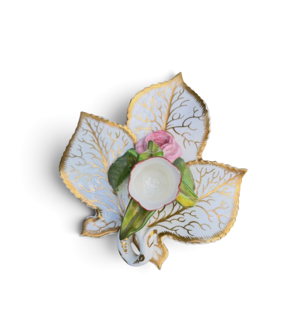 An English porcelain chamberstick designed as a leaf base with a central tulip-shaped candle sconce hand-painted in red, green, pink, and gold. View VII
