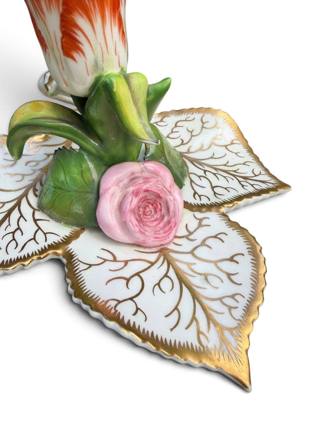 An English porcelain chamberstick designed as a leaf base with a central tulip-shaped candle sconce hand-painted in red, green, pink, and gold. View VIII