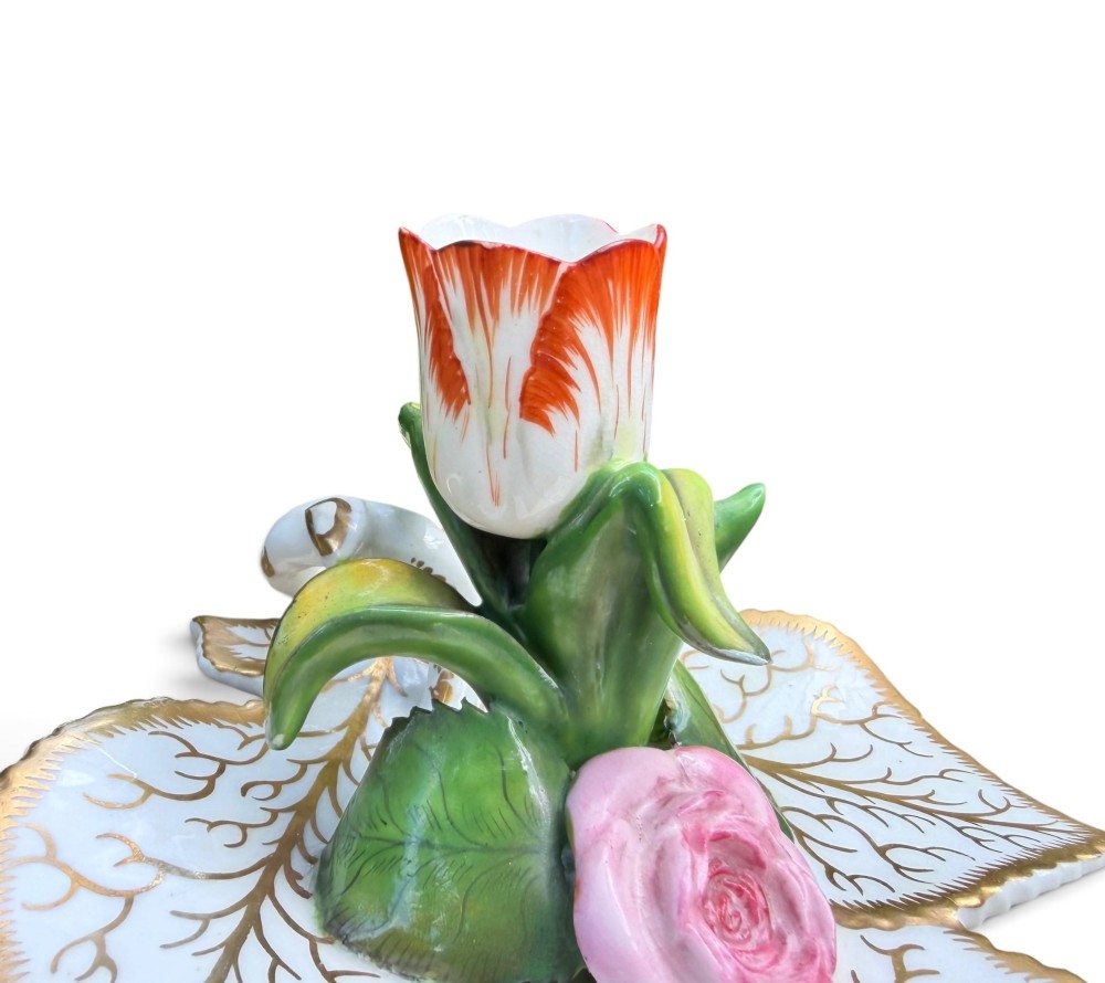 An English porcelain chamberstick designed as a leaf base with a central tulip-shaped candle sconce hand-painted in red, green, pink, and gold. View IX